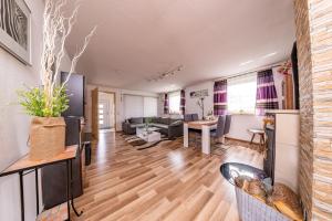 a living room with a couch and a table at Ferienwohnung Leipzig- Hirschfeld Apartments in Leipzig