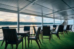 a group of tables and chairs with a view of the water at Grand Amazon Expedition in Manaus