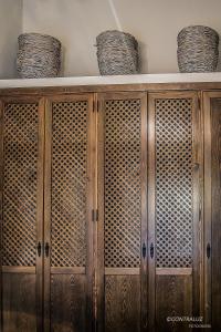 a wooden cabinet with two baskets on top of it at La Posada De Lola in El Molar