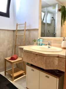 a bathroom with a sink and a chair and a mirror at Albatros Golf View 2394 in Casares