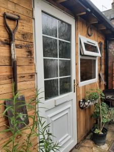 a door and window on a wooden building at Salisbury Guest House - free parking in York