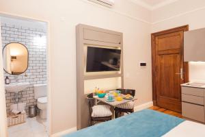 a room with a bathroom and a table with food on it at Sarmiento Flats in Buenos Aires +99 photos