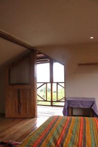 sypialnia z łóżkiem i dużym oknem w obiekcie Diosa de la Montaña w mieście Jama