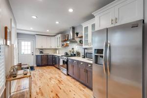 a kitchen with a stainless steel refrigerator and wooden floors at Trendy Fairmount Gem-5 star Location, Roof Deck, PARKING, GR8 for FAMILIES in Philadelphia