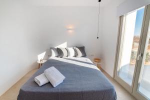 Postel nebo postele na pokoji v ubytování CAMPO SUITES