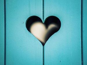 a heart cut out of a blue door at Kiskovász Pajta & Inn in Nagytevel