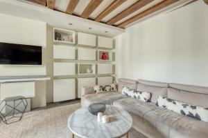 a living room with a couch and a table at Large and Modern 1Brd Flat at Lovely Saint Germain in Paris