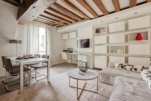 a living room with a couch and a table at Large and Modern 1Brd Flat at Lovely Saint Germain in Paris