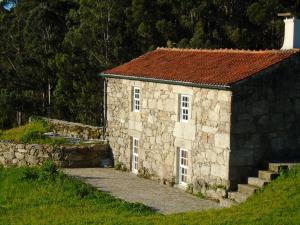 a small stone building with a red roof at Charming House in Andeviso with Mountain View in Arcos de Valdevez