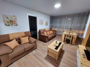 a living room with a couch and a table at Piso El Prau in Suances