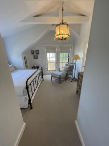 a bedroom with a bed and a chandelier at 52 Union in Nantucket