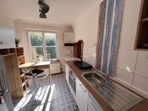 a small kitchen with a sink and a table at Traumhaftes Poolhaus am idyllischen Ortsrand in Blaubeuren