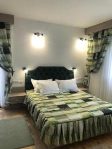 a bedroom with a large bed with two pillows at NUT HOUSE Retezat in Nucşoara