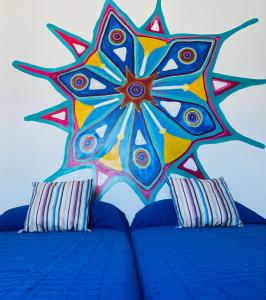 a painting of a star on top of a bed at CASA EL PARAISO in Coín