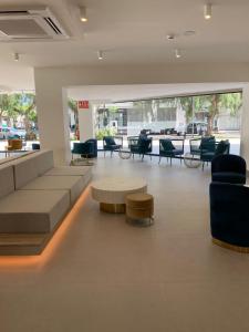 a lobby with a couch and chairs and a table at New & Beautiful Loft in Puerto Banus in Marbella