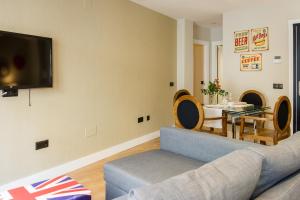 a living room with a couch and a table at AB Apartamentos Museum in Málaga