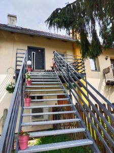 a set of stairs leading to a house at Apartament Sielsko-Wiejsko in Szczytna