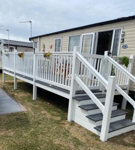 a white railing and stairs on a mobile home at Heron 41, Scratby - California Cliffs, Parkdean, sleeps 6, pet friendly, bed linen and towels included - close to the beach in Scratby