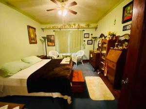 a bedroom with a bed and a table and chairs at Historic Home - sleeps 4 adults - 1 mile to Ft. Sill in Lawton