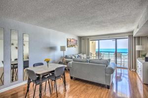 a living room with a couch and a table with chairs at North Myrtle Beach Oceanfront Condo with Pool! in Myrtle Beach