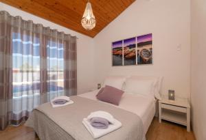 a bedroom with a bed with towels on it at Villa Anabella in Supetar +63 photos