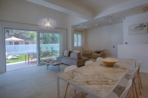 a living room with a table and a couch at THE QUAD Luxury Villas in Lygia