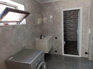 a bathroom with a sink and a washing machine at Частный дом Ленкорань in Lankaran