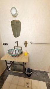 a bathroom with a sink and a mirror at Riad Nohad Marrakech Villa Privatisée in Oulad Boudene +47 photos