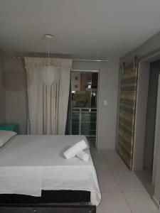 Giường trong phòng chung tại Hotel Oiticica