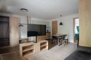 a living room with a large flat screen tv at Apartments with SAUNAS - Gobi in Podčetrtek