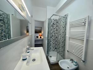 a white bathroom with a sink and a shower at Dreamsrome Lux in Rome