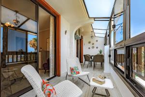 a living room with white chairs and windows at LUX Parque Santiago2 Las Americas First Line in Playa de las Americas