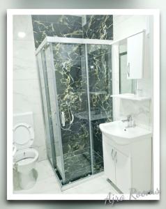 a bathroom with a shower and a toilet and a sink at Ajro Rooms in Struga +29 photos