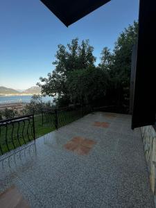 a walkway with a view of the beach and the ocean at Escape to History in a Stunning Stone House with Garden and Sea View in the Heart of Alanya in Alanya