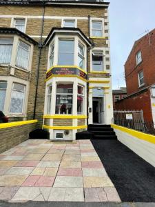 a building with a yellow and white facade at Sam Residence Hotel in Blackpool