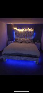 a bedroom with a bed with lights on it at Cabin with Hot Tub in Aberdeenshire in Gamrie