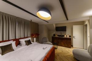 a bedroom with a large white bed and a living room at שירת צפת in Safed