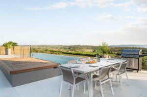 a patio with a table and chairs on a deck at Villa Albina & Domenica in Zadar