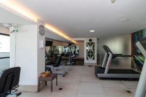 a gym with treadmills and exercise equipment in a room at Suite Particular Brasília in Brasilia