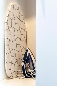 a surfboard leaned against a wall next to a mirror at Hotel Gringo in Piła