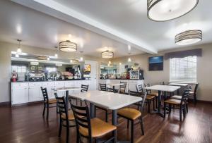 a restaurant with tables and chairs and a kitchen at Best Western Parkside Inn in Frankfort