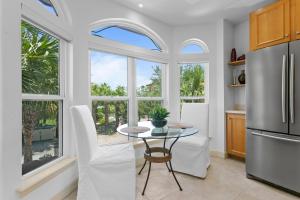 a kitchen with a table and some windows at Bradenton Beach Club #13 in Bradenton Beach