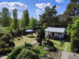 a view of a garden with a house at Renovated wooden cottage 300 meters from the beach in Ragaciems