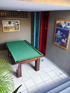 a green ping pong table in a room at Pousada Boi Bumbá Praia in João Pessoa