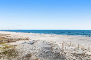 a beach with a lot of people in the water at Island Shores 455 in Gulf Shores