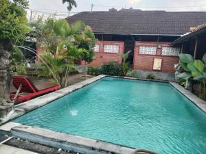 a swimming pool in the backyard of a house at Soca House in Ubud