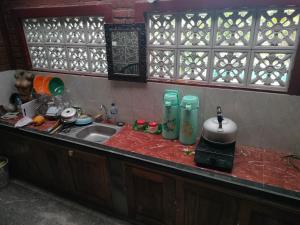 a kitchen with a sink and a counter top at Soca House in Ubud