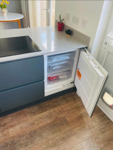 a kitchen with a white counter with an open drawer at Mia Property in Bristol