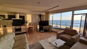 a living room with a view of the ocean at Pirita Beach View Suites in Tallinn