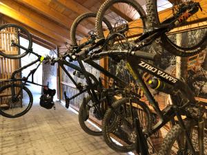 a group of bikes hanging on a wall at Garden Wellness Hotel S in Andalo